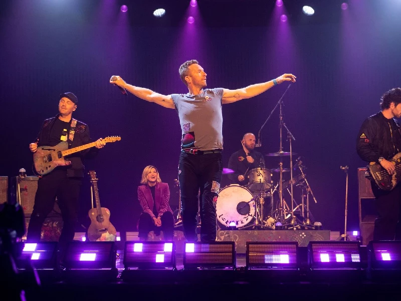 Will Champion of Coldplay performs on stage at Wembley Stadium